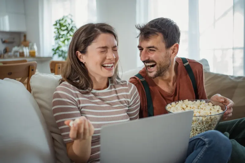 Happy couple relaxing at home after orthodontic treatment in Prescott Valley, AZ